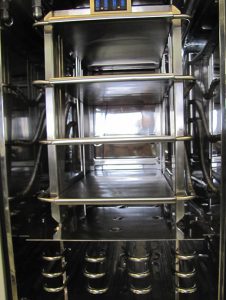 Product chamber with stopper shelves, exposed coil condenser and baffle